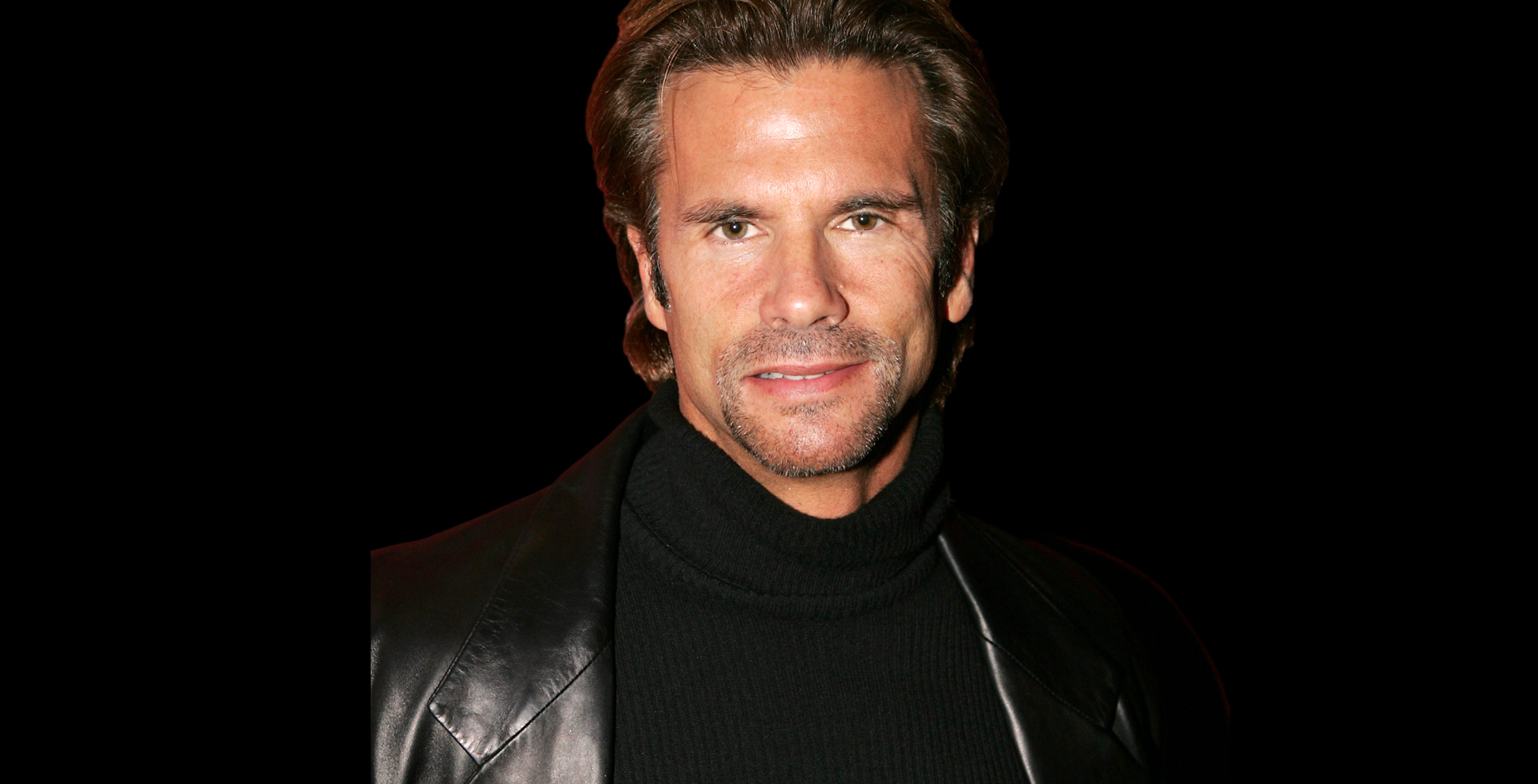 bold and the beautiful alum lorenzo lamas in stubble wearing a black jacket against a black backdrop