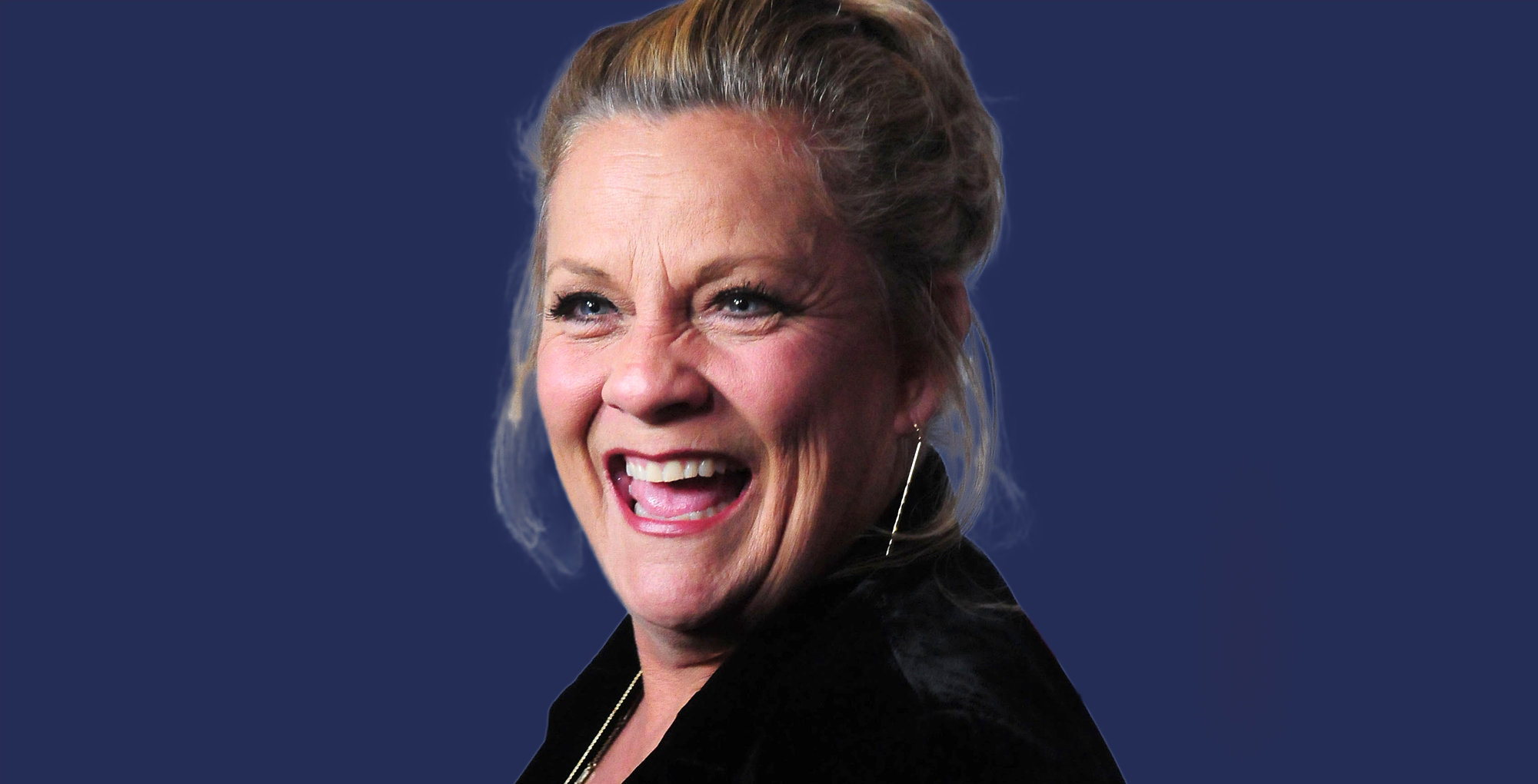 veteran soap star kim zimmer smiling for her birthday with a blue background