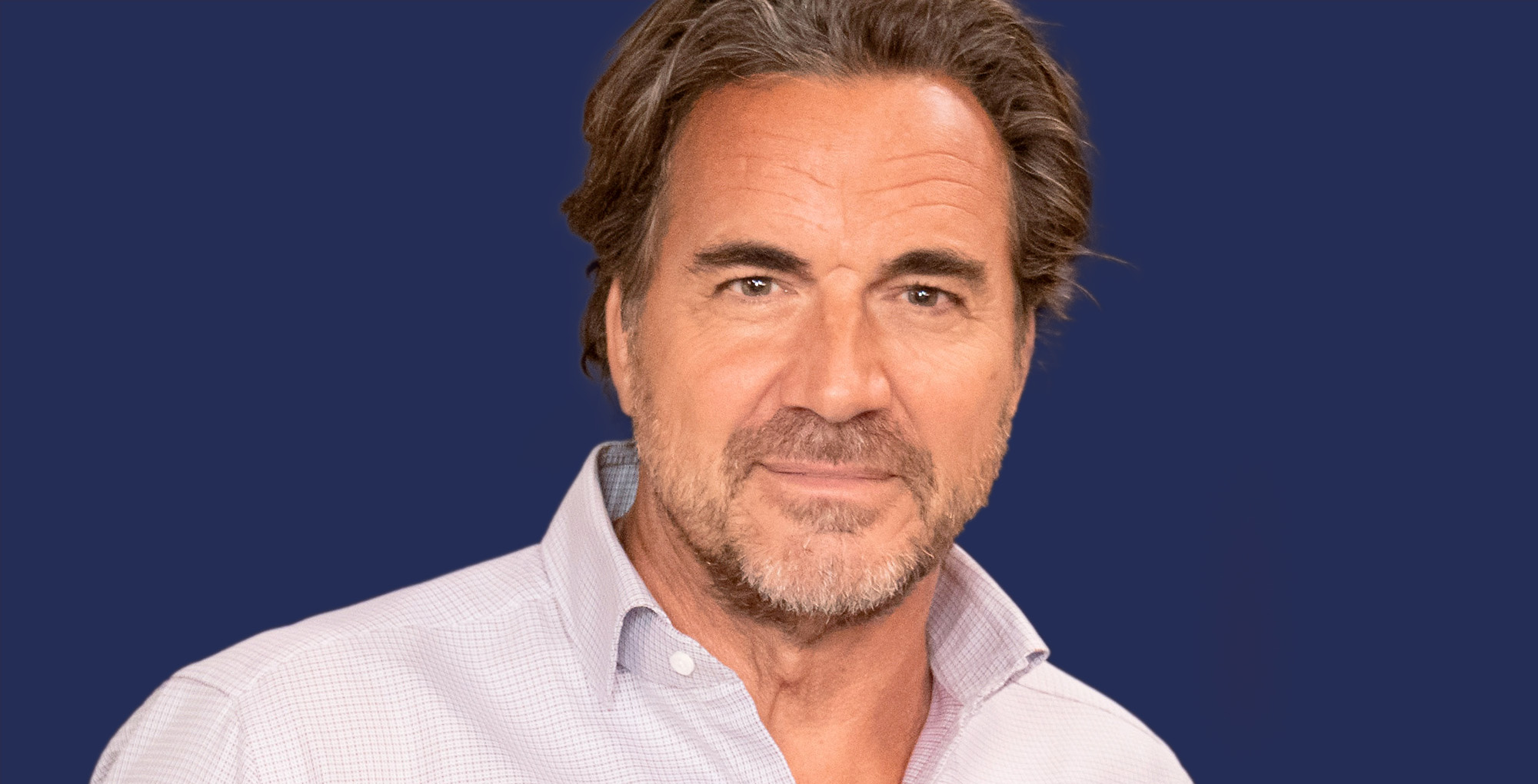 thorsten kaye of the bold and the beautiful against a blue background