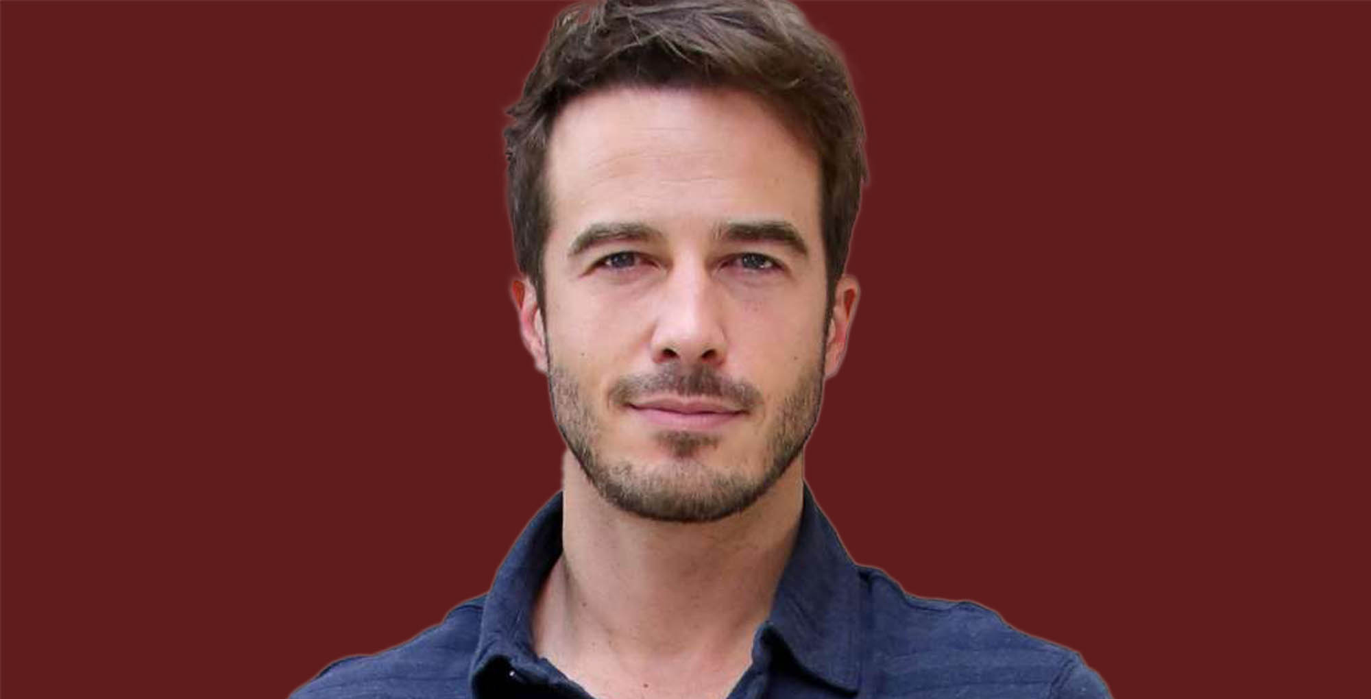 general hospital's ryan carnes wearing a blue collared shirt on a red background.
