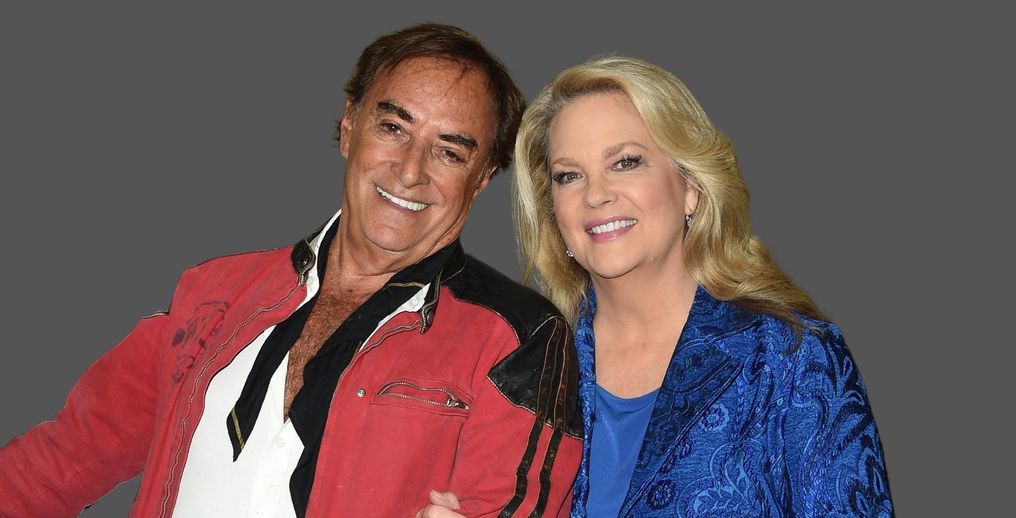 thaao penghlis in red and leann hunley in blue posing against a gray background days of our lives