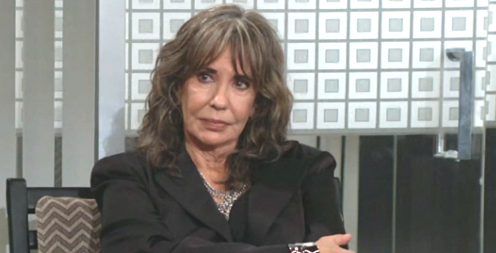 young and the restless spoilers jill foster abbott sitting on an office couch, looking unhappy