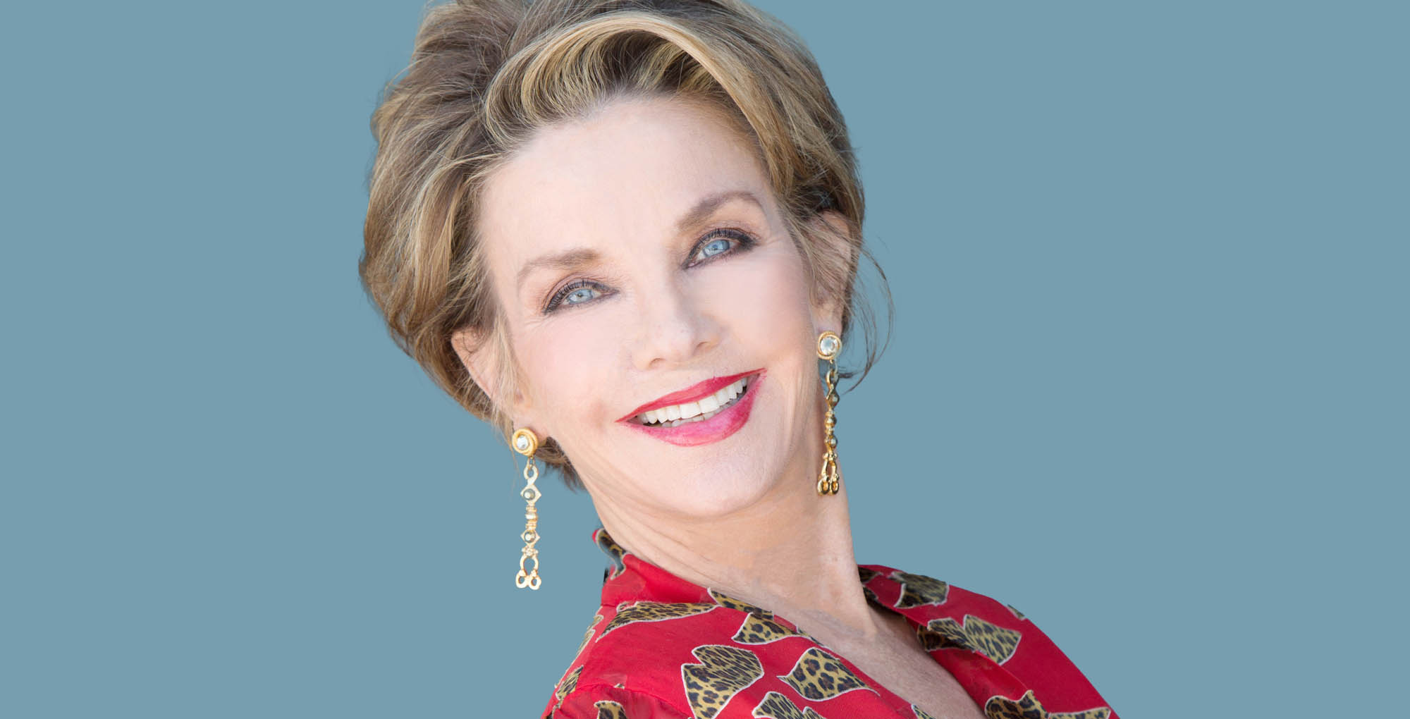 judith chapman, young and the restless, wearing red and smiling.