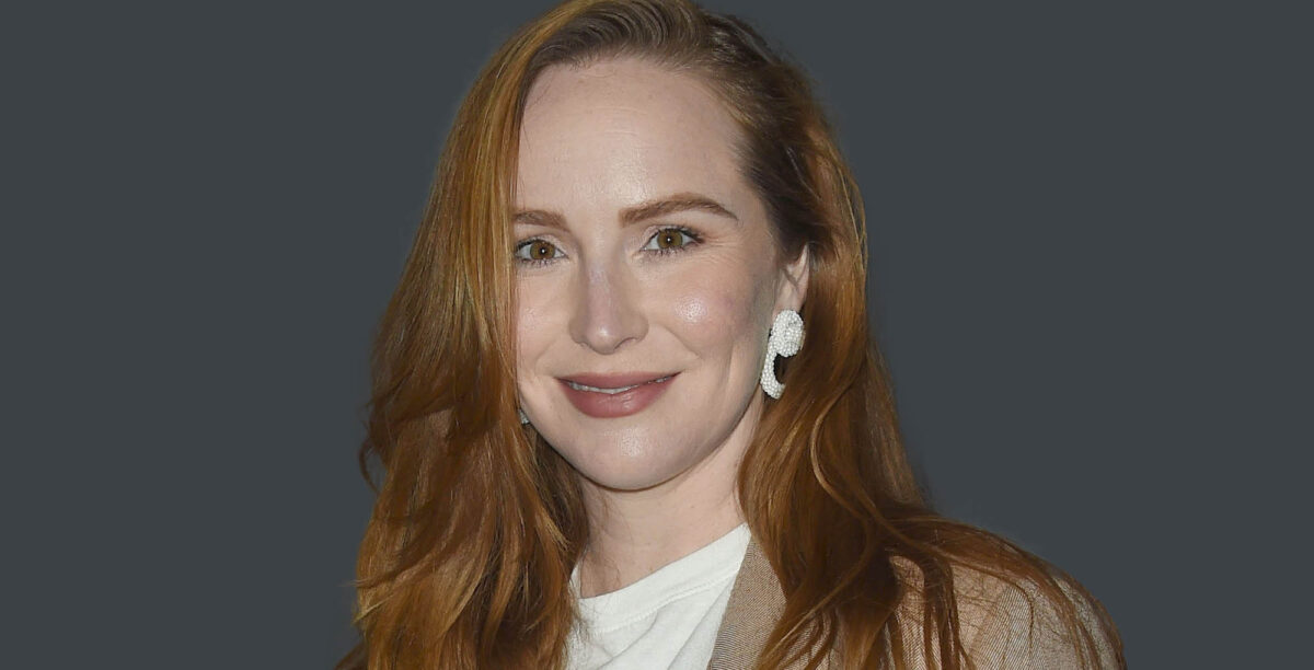 the young and the restless star and new mom camryn grimes smiles against a gray background.