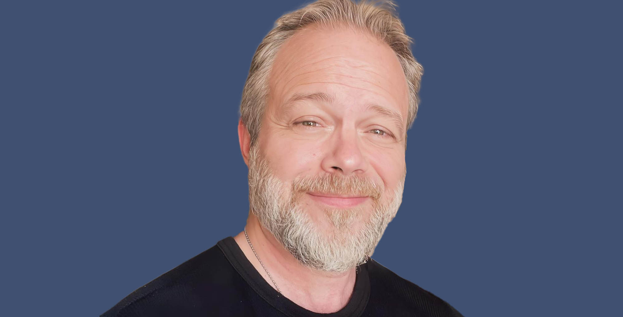 young and the restless star brian gaskill wearing black against a blue background.