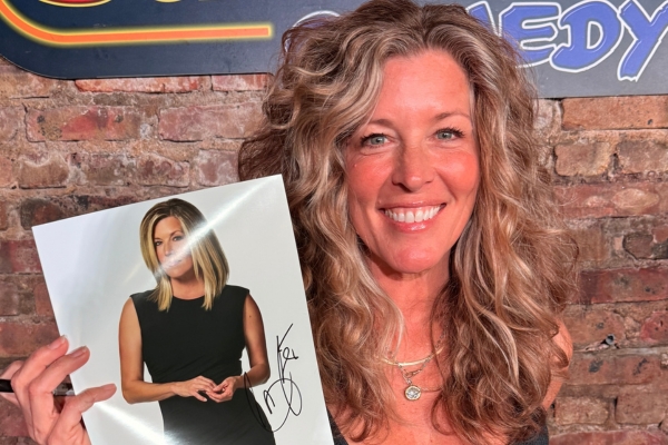 Laura Wright holds up autographed photo of herself